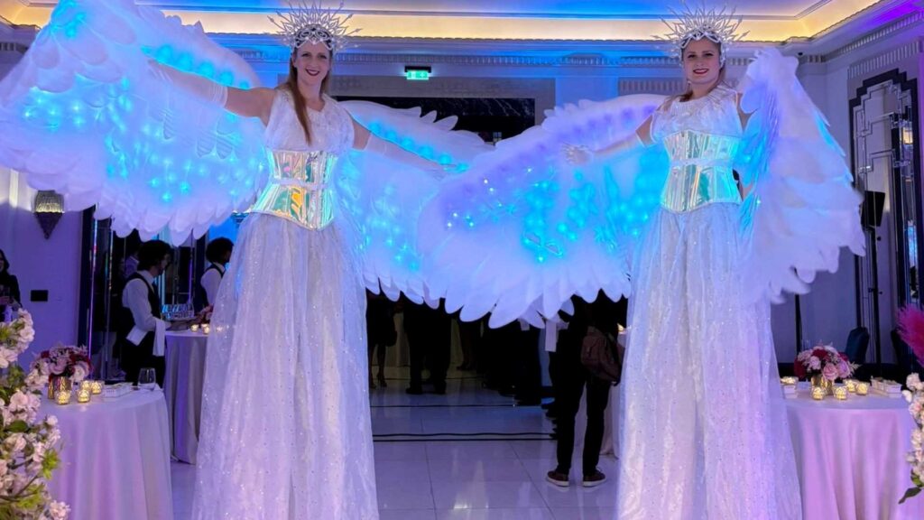Two LED Performer greeting guests at an event.