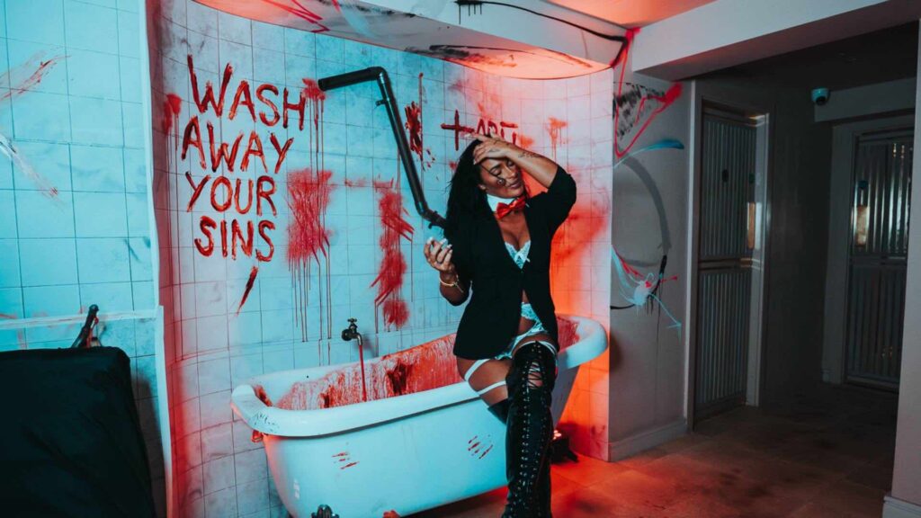 Gruesome bathtub scene recreated from movie SAW I for London TABU with guest posing in the bathtub.