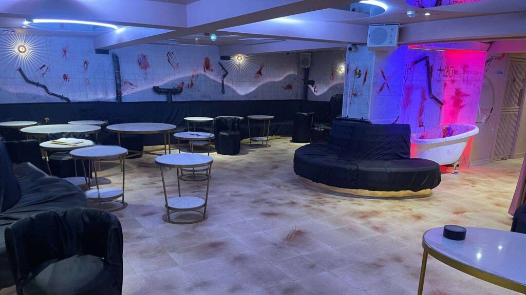 The inside of TABU club featuring a SAW themed Halloween transformation with blood smeared walls and iconic illuminated bathtub.
