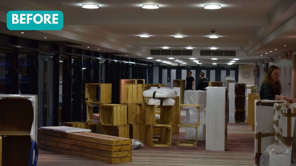 A before shot of pallet furniture disassembled before construction at a conference event.