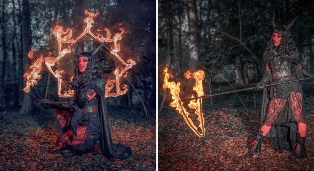 Devil fire performer in red and black costume with fire props for halloween events. 