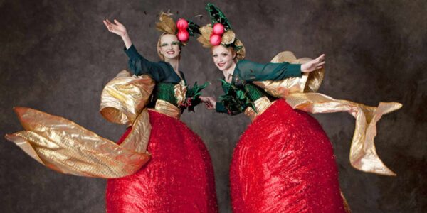 Traditional bell themed Christmas stilt walkers.