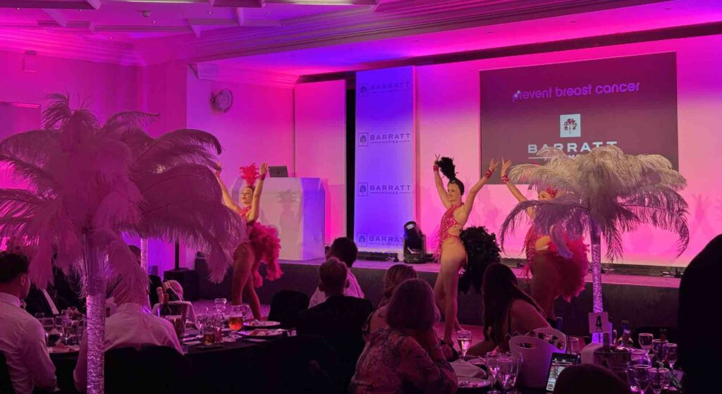 Las Vegas show girls performing for audiences at Barratt Homes charity gala at Whittlebury Hall.