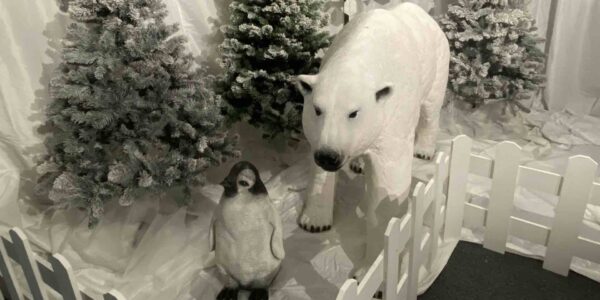 Polar bear and penguin props as part of traditional grotto.
