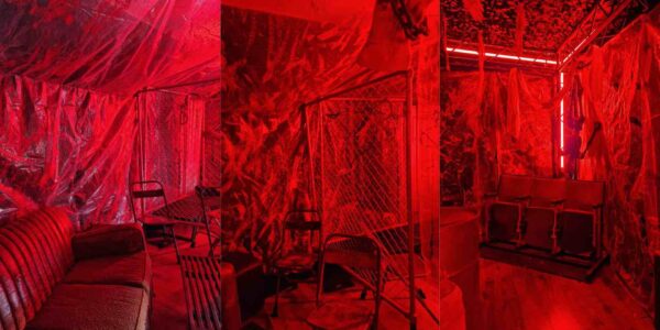 Details from butchers slaughterhouse theme including props, barrels, hanging body parts and blood red lighting.