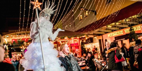 Ice-Queen-Stilt-Walker-Towering-Over-Crowd