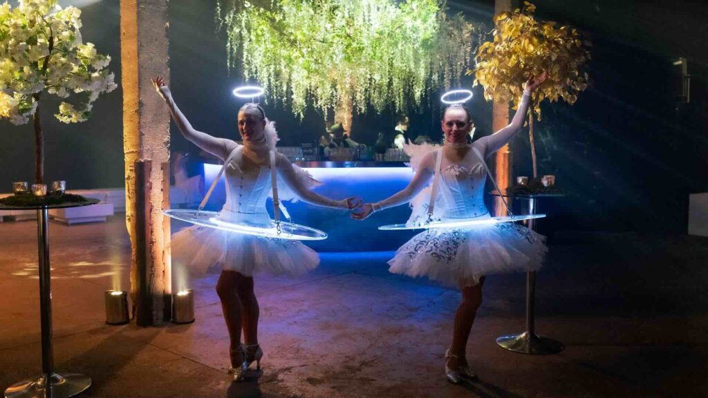 LED Roaming Tables outside dressed as angels at event