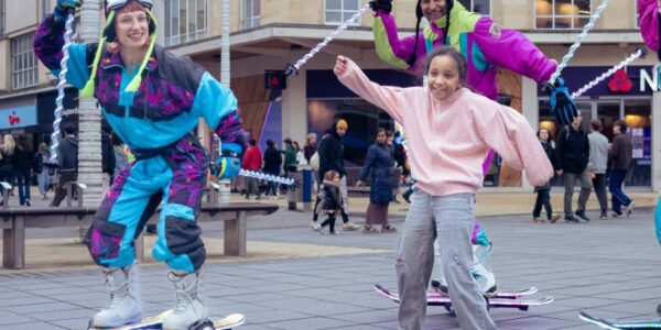 Skiers Performing With Crowd