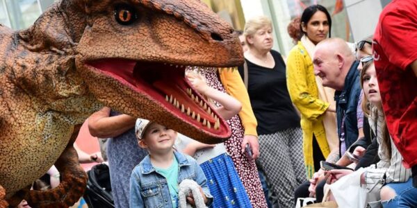 Walkabout dinosaur performing in town centre