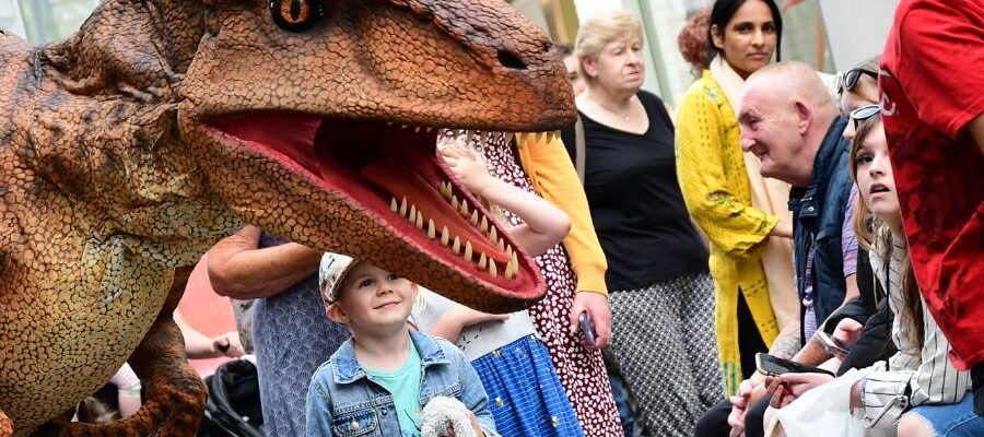 Walkabout dinosaur performing in town centre Walkabout dinosaur performing in town centre