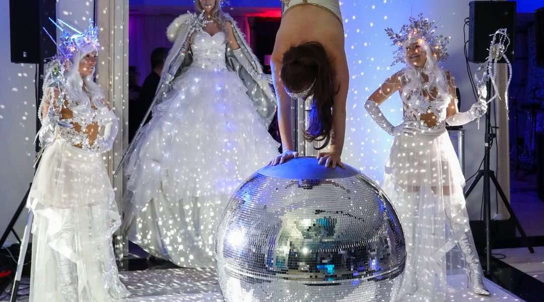 Performer-Balancing-On-Glitter-Ball-Winter-Wonderland-Entertainers