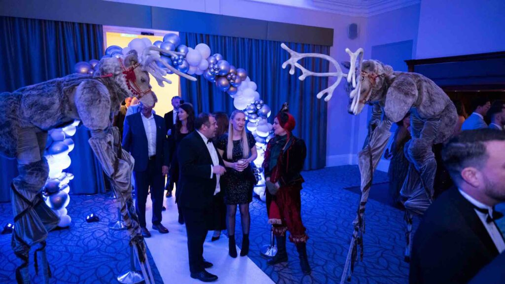 Reindeer stilt walkers at a winter wonderland theme event. 