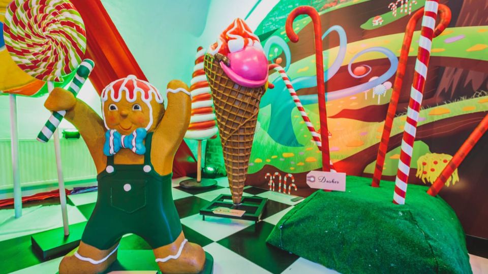 Oversized giant candy canes, lollipops, ice cream cone and gingerbread as part of a candy dreams themed production.
