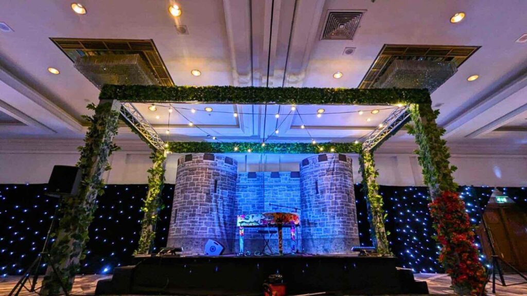 Bespoke custom stage with tall structures using the height of the building to create power.