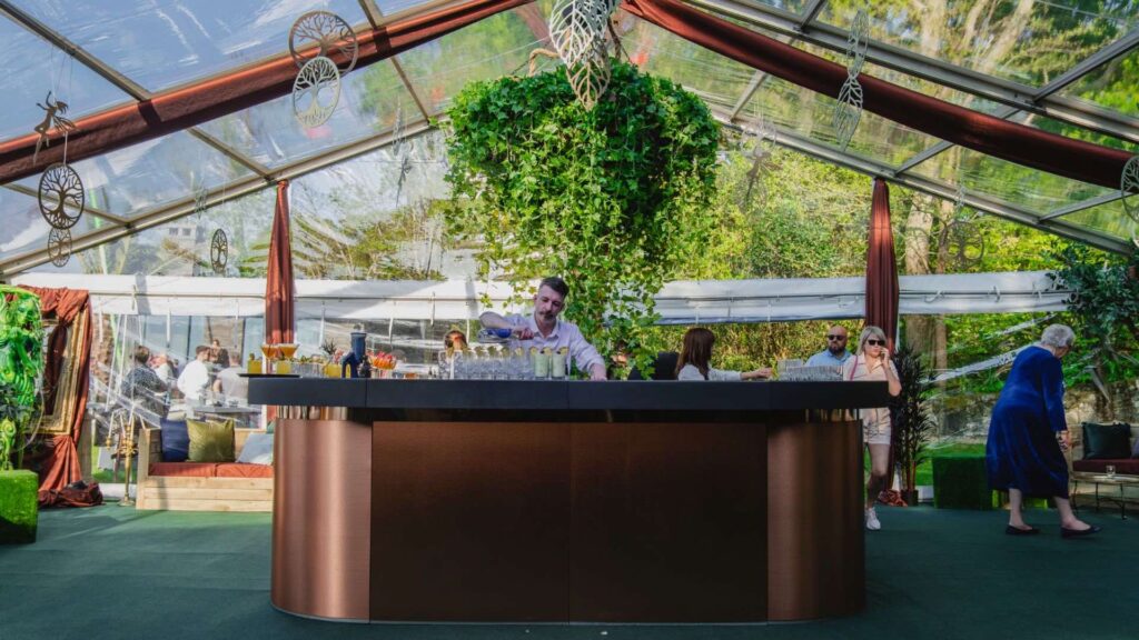 Greenhouse bar outside with greenery in the sunlight