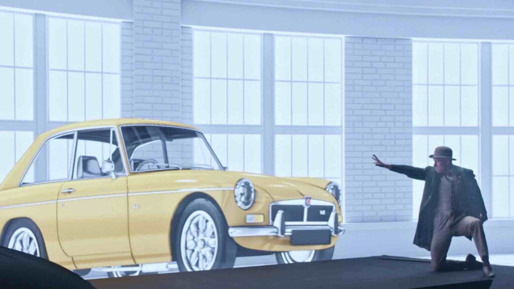 Entertainer in front of a customised LED screen showing a car