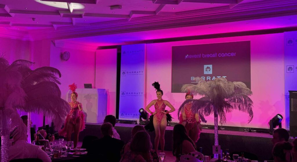 Las Vegas show girls performing for audiences at Barratt Homes charity gala event.