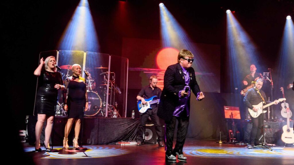 Elton John tribute act performing on stage