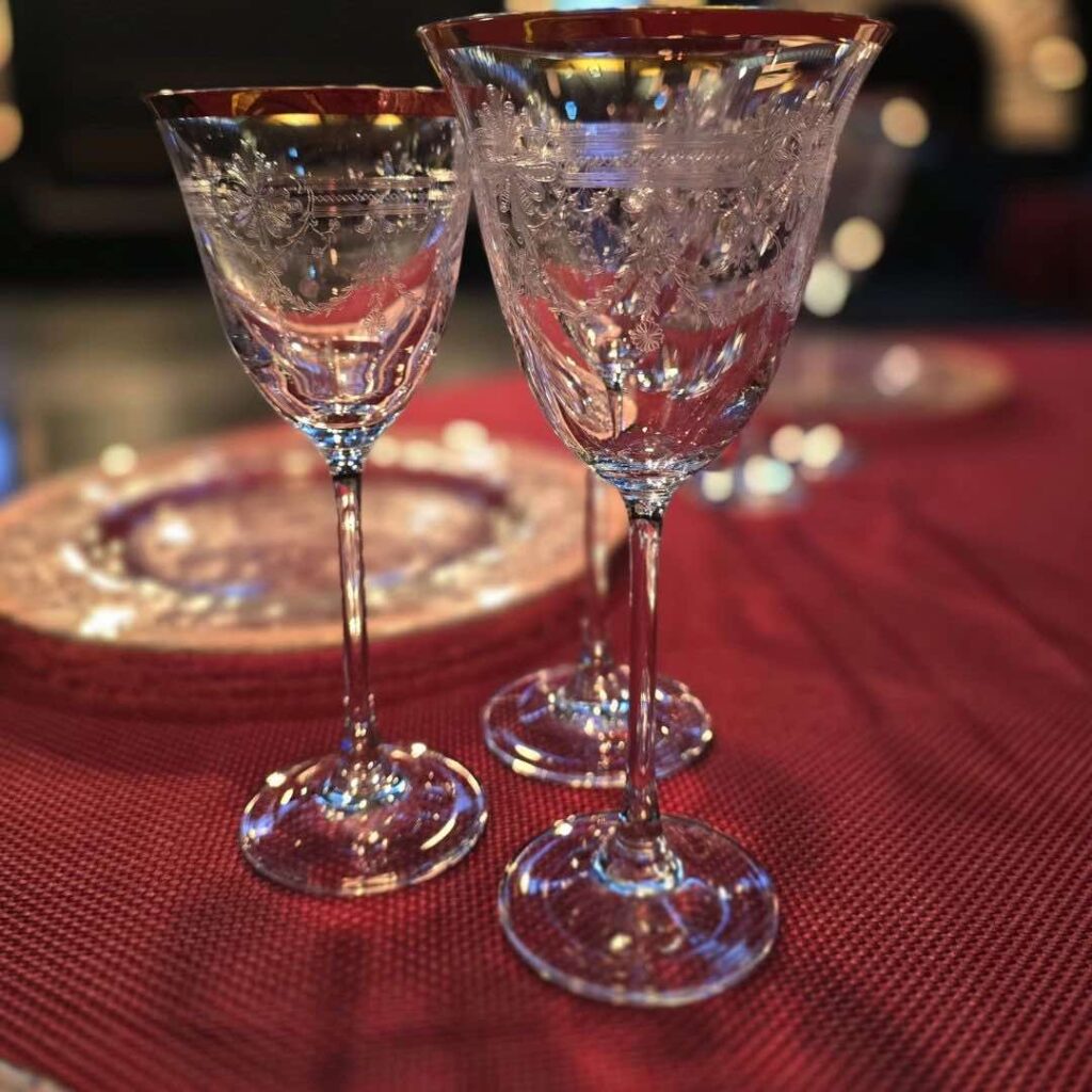 Refine glassware sat on gala dinner table with red cloth as part of final touches. 