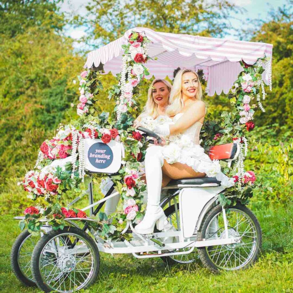 Entertainers sat on a floral bicycle