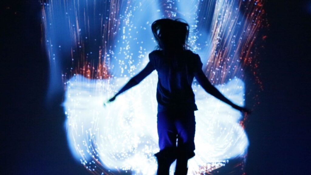 Colourful digital walls and mirrors with a silhouette in front