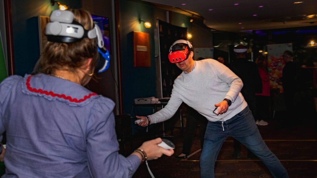 Event guests engaging in Metaverse arcade game with headsets.