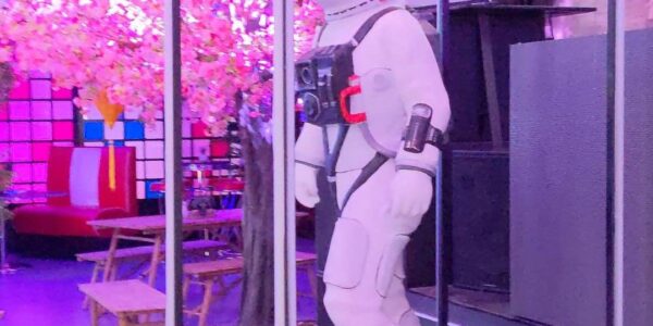 Astronaut space prop inside glass casing used for sci fi event theming.