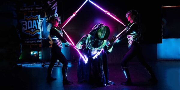 Futuristic performers entertaining guests at a sci-fi themed event.