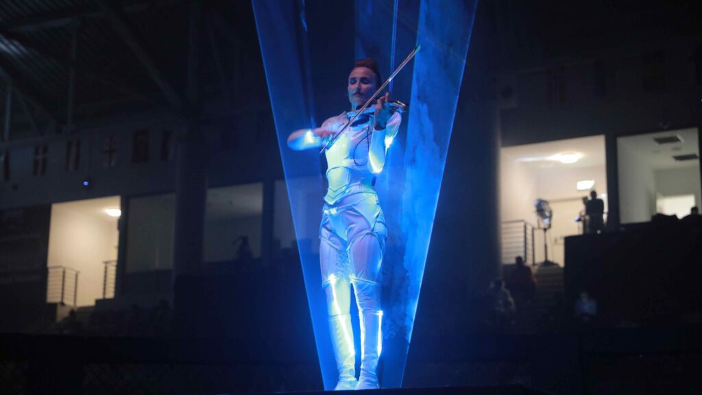 LED laser harpist performing at a space themed event.