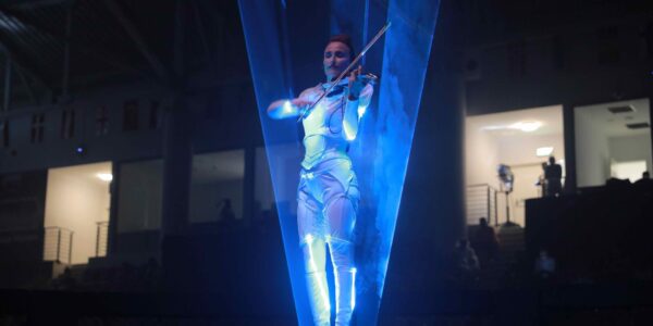 LED laser harpist performing at a space themed event.