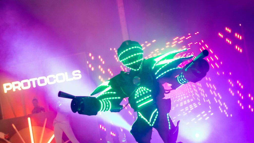 An image of a walkabout glow bot performing at a conference