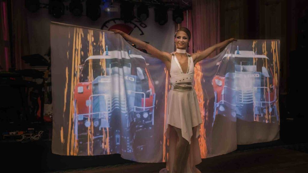 Performer lifting her dress to be used as a projection screen