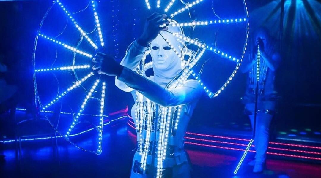 Unique white themed futuristic dancer performing at a brand activation.