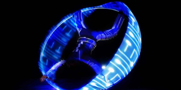 LED cyr wheel performer entertaining at a sci-fi themed event.