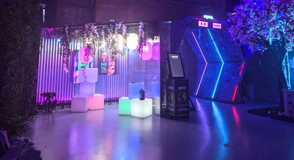 LED cube photo installation area created for guest to take photos at a futuristic themed event with portal entrance next to it.