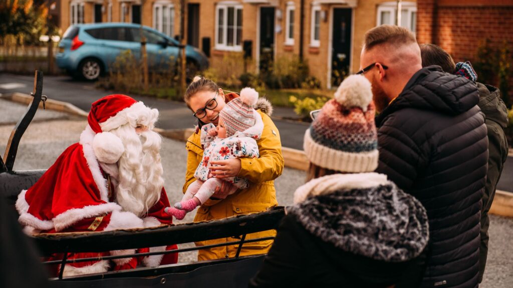 An image of Santa greeting young children at a community event