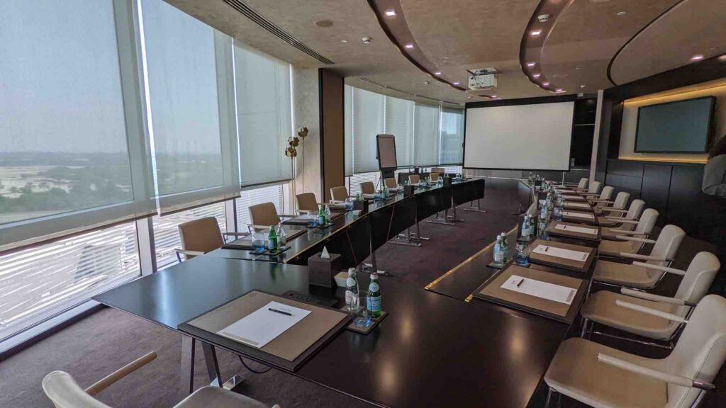 A conference event with a projection screen and table for all