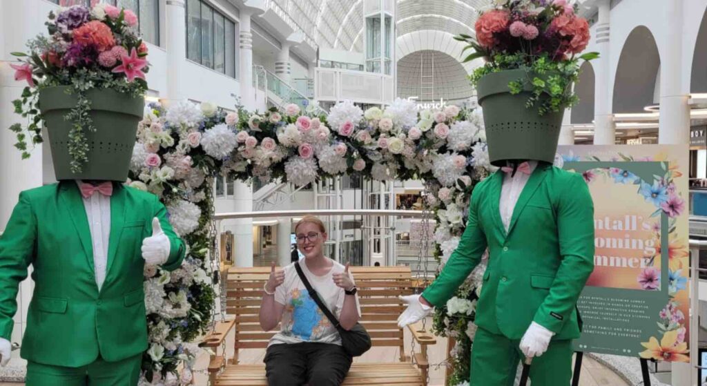 Flower pot men hired for a spring themed retail activation posing with guest in shopping centre.