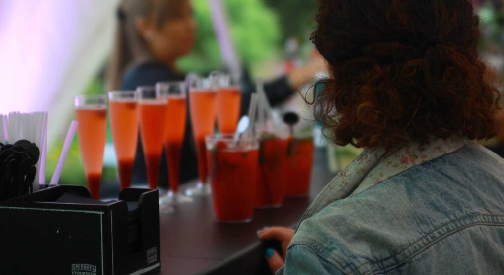 Drinks being served at a mini-festival company event in tall glasses.