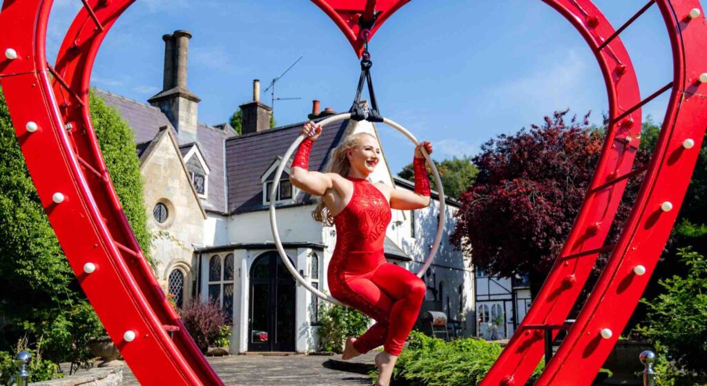 Stunning heart aerial act in freestanding heart prop at mini festival company event.