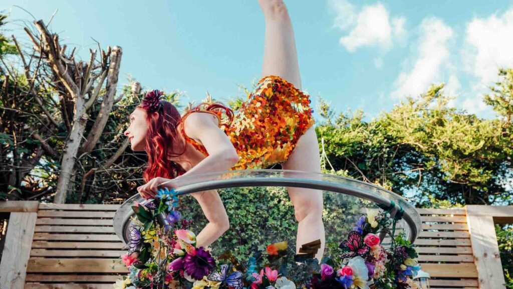 A Giant floral martini glass dancer showing off her flexibility