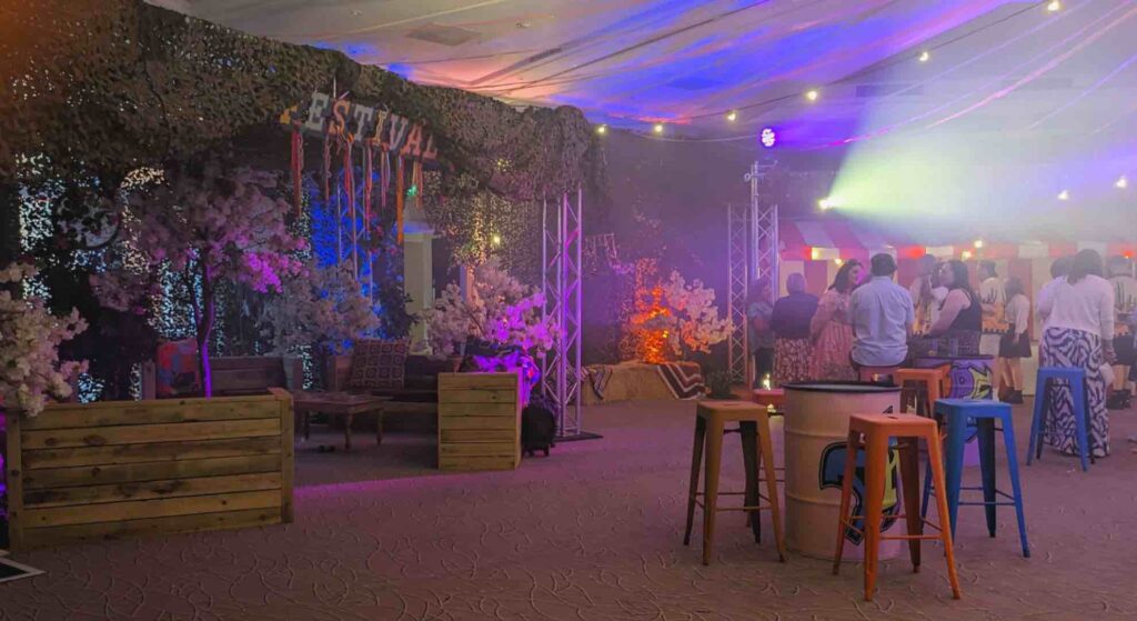 An indoor mini-festival company event with bespoke festival sign, seating and chill out zones.