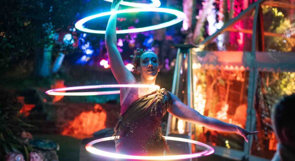 Stunning LED hula hoop act with LED rings performing at mini-festival company event.