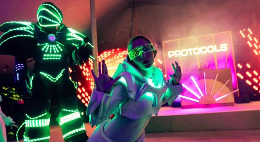 Robot and LED entertainers posing for the camera at a conference festival in Magna Carta.