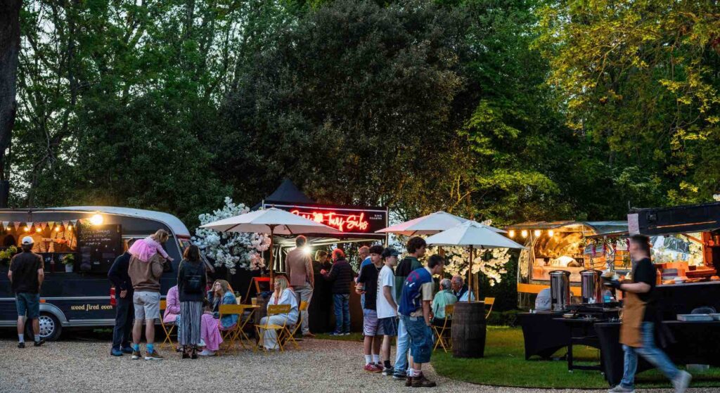 A hub of food trucks and delicious dining at a small festival event.