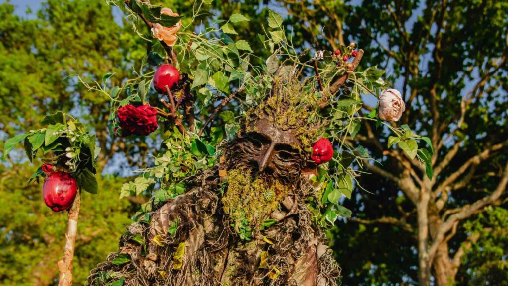 A tree stilt performer at an outdoor event