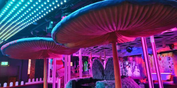 Neon mushroom lounge in an enchanted garden.
