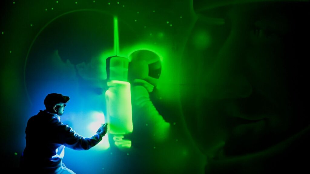 A light painter creating a giant mural