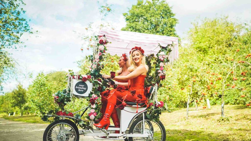 A gorgeous pair of models on a floral themed bicycle for events