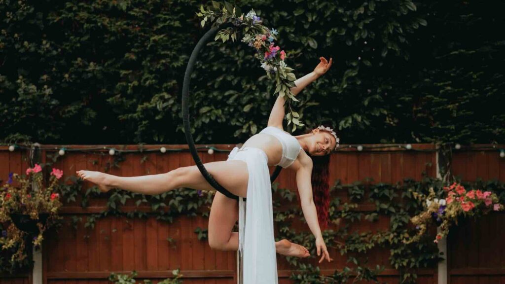 A striking performer in a hoop themed in floral clothing